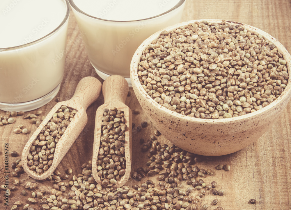 Hemp milk, seeds on wooden background . Close Up . Hemp milk, seeds on wooden background . Close Up .