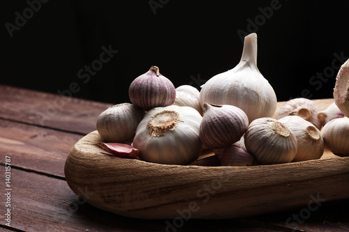 Garlic. Garlic Cloves and Garlic Bulb in vintage wooden bowl.