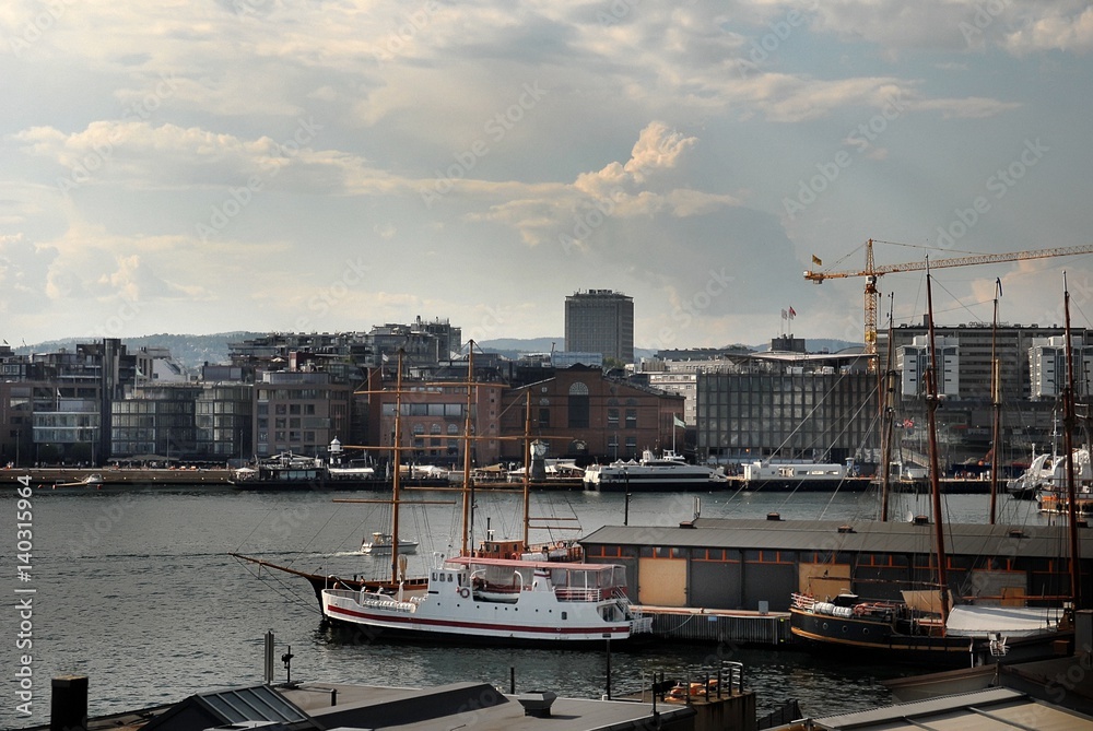 View of the Oslo's harbour promenade, Norway. The Oslo Norway harbor is one of Oslo's great attractions. Situated on the Oslo Fjord, the harbor front is a popular destination for tourists.