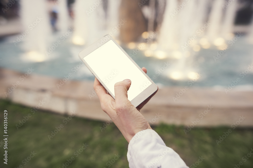 female hand holding a smart phone with a blank white screen mockup female hand holding a smart phone with a blank white screen mockup