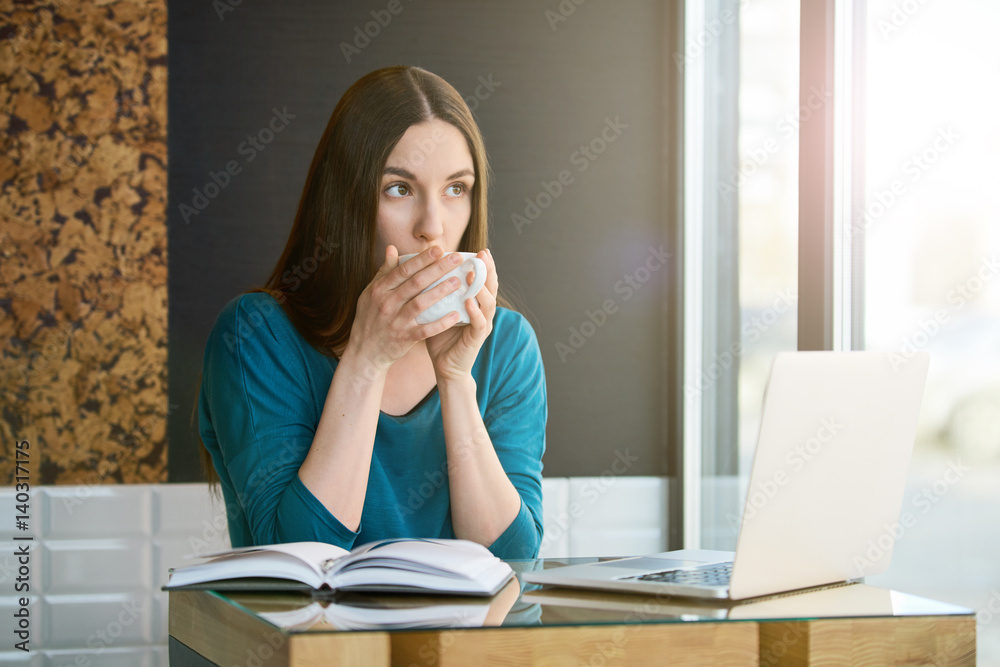 Young freelancer woman having coffee at the cafe Young freelancer woman having coffee at the cafe