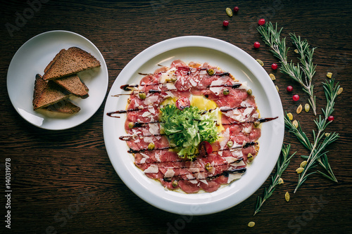 Top view of carpaccio in a white plate