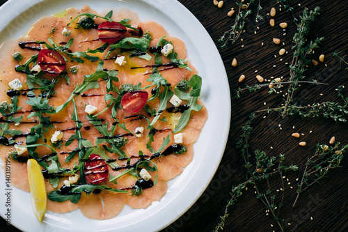 Salmon carpaccio in a white plate