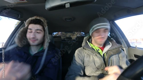 Two guys in the car dancing modern dances in the winter. Video full hd.