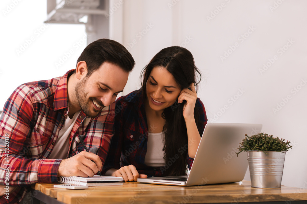 Couple working together at home. Planning a wedding Couple working together at home. Planning a wedding