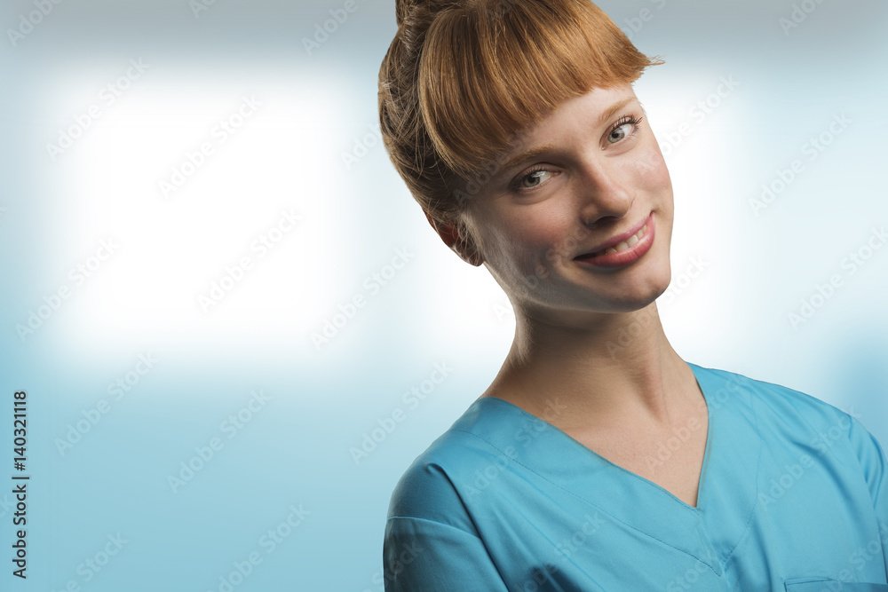 Fototapeta premium close up on a beautiful young woman nurse or doctor with red hair
