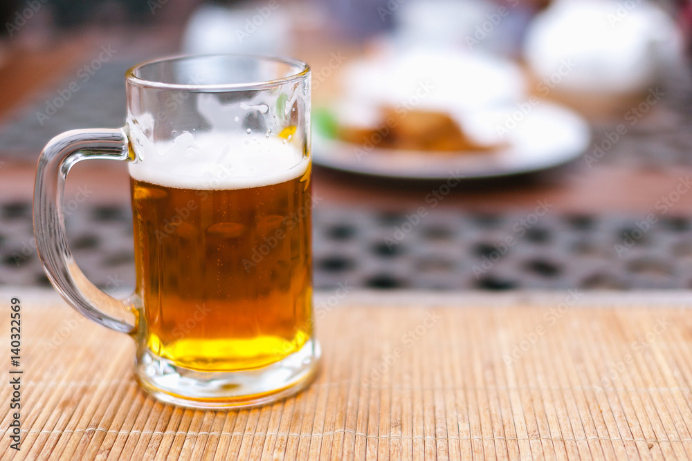 beer mug with beer on a table outside beer mug with beer on a table outside
