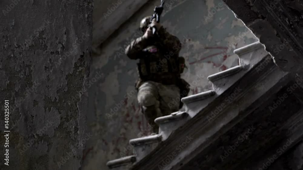 Military men with arms defend the building and go up the stairs Military men with arms defend the building and go up the stairs