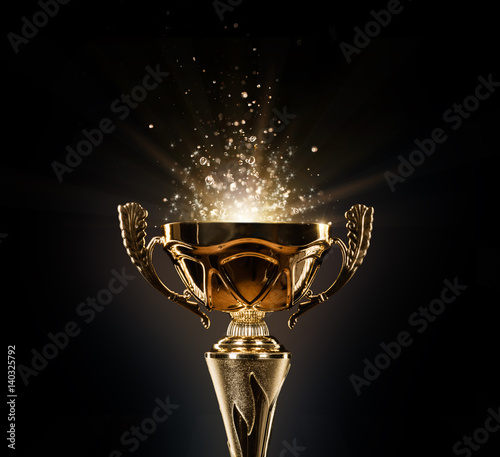 Leinwand Poster Champion golden trophy on black background