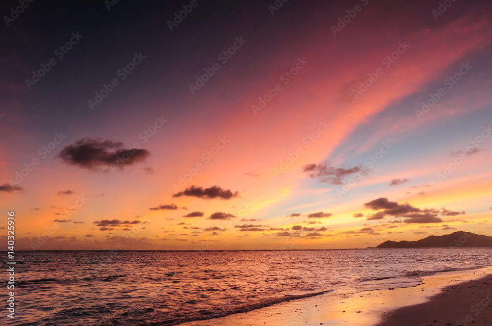 Spectacular sunset above a paradise island