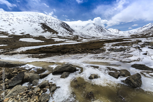 Along way at Khardung La Pass in Ladakh, India. Khardung La is a high mountain pass located in the Ladakh region of the Indian state of Jammu and Kashmir. The elevation of Khardung La is 5,359 m.