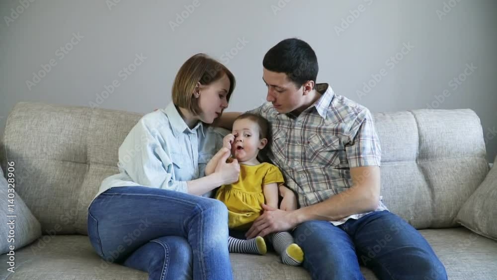Happy family sitting on the couch. Their little daughter wants to sleep. Family concept. Full Hd Slow Motion Stock Footage.
Happy family sitting on the couch. Their little daughter wants to sleep. Family concept. Full Hd Slow Motion Stock Footage.