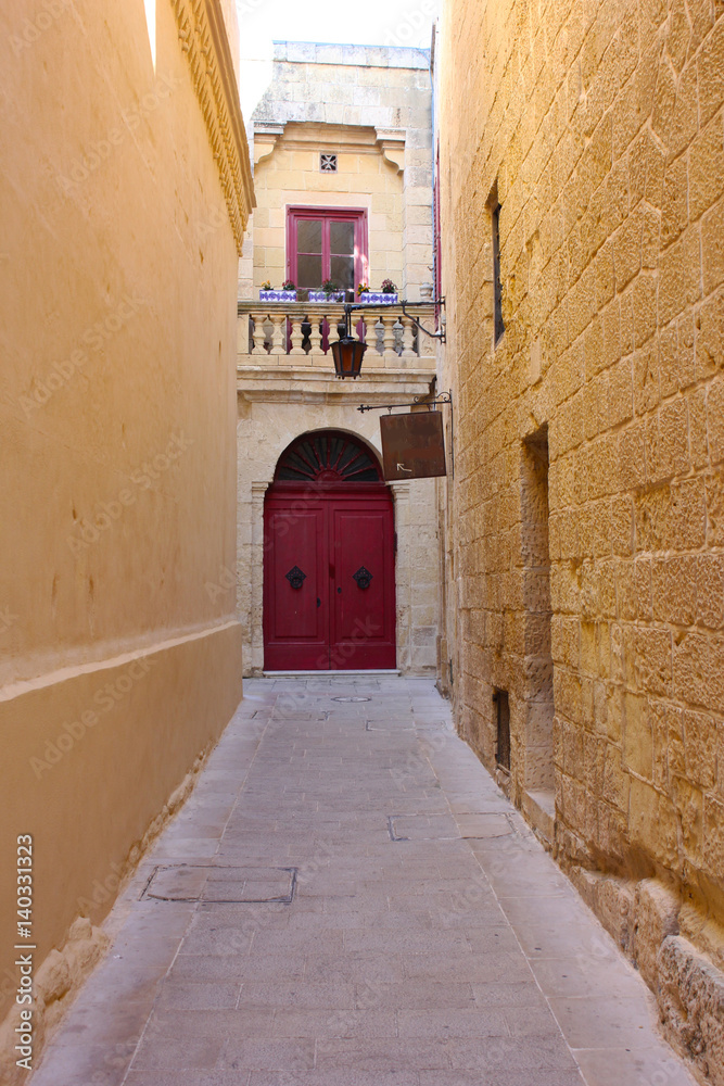 Narrow street with a lantern in old town Mdina, Malta
