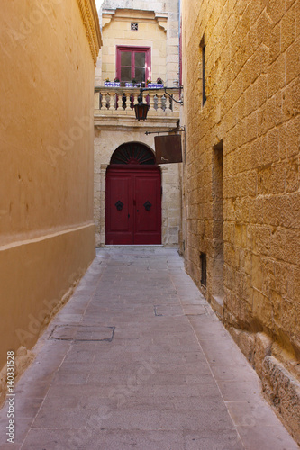 Narrow street with a lantern in old town Mdina, Malta