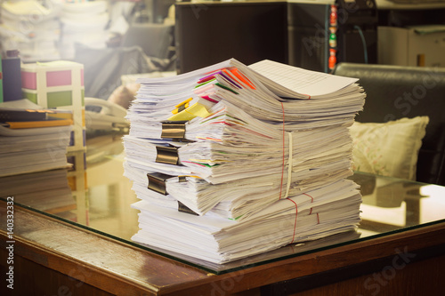 Pile of documents on desk at workplace