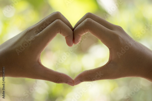 hearth make by two hands with blur background