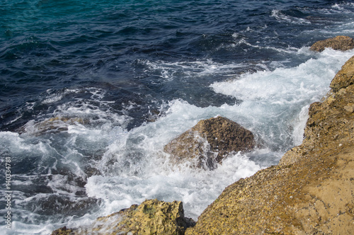 The sea around the breakwater rocks, background.