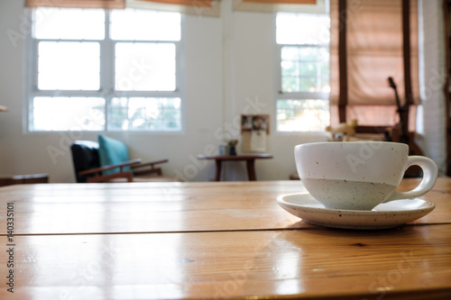 A cup on wooden table in coffee shop