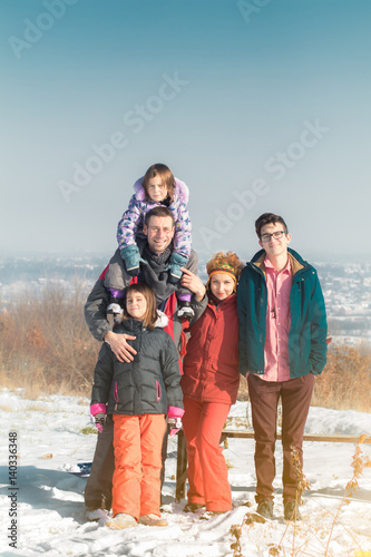 Portrait of large cute happy family in winter snow outdoors