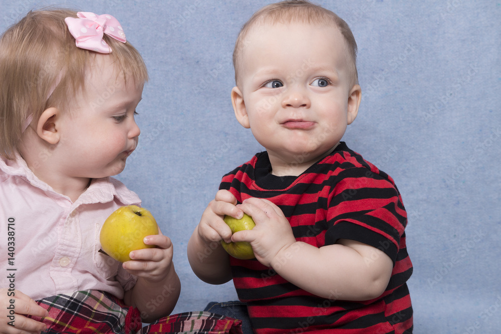 Two funny kids playing with apples. Retro style Two funny kids playing with apples. Retro style