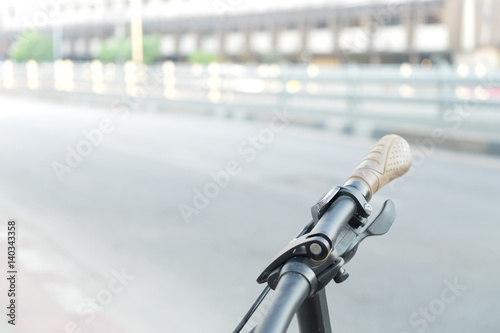 Hand bike with blur road or street in the city when empty traffic flow for copy space background