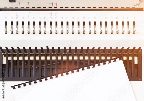 White bookbinder tool in sunlight