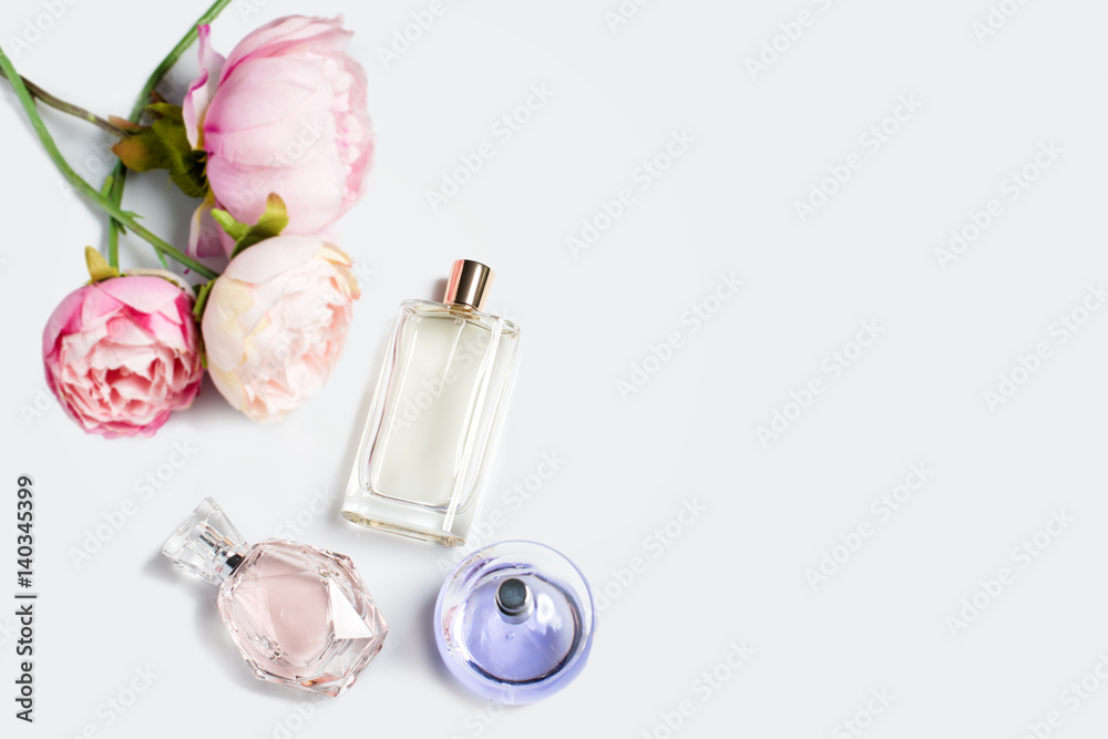 Perfume bottles with flowers on light background. Perfumery, cosmetics,  fragrance collection. Free space for text. foto de Stock | Adobe Stock