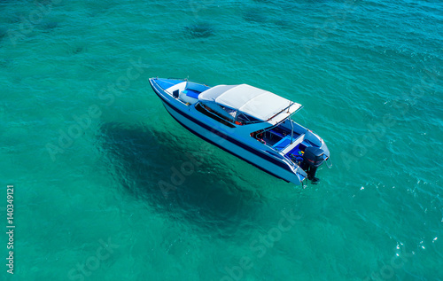 Speed boat in the sea.Aerial view. Top view.amazing nature background.The color of the water and beautifully bright. © MAGNIFIER