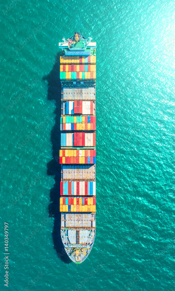 container ship in import export and business logistic.By crane ,Trade Port , Shipping.cargo to harbor.Aerial view.Top view.