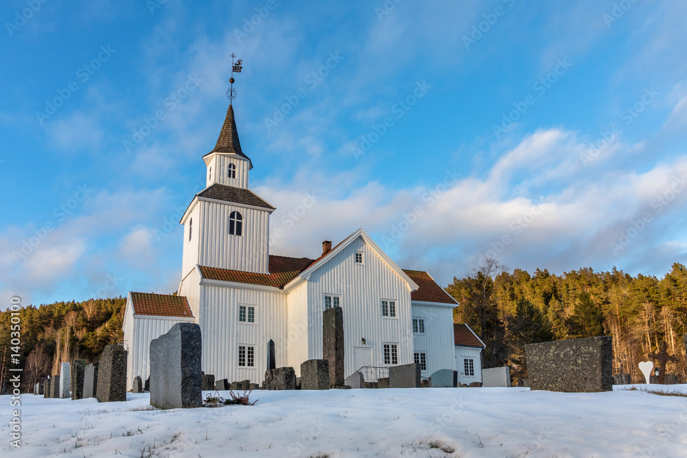 Church in winter with snow and blue sky in Iveland Norway