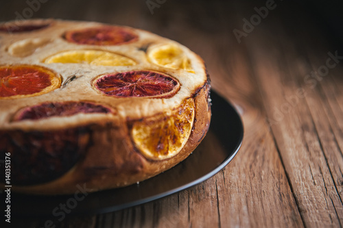home made citrus cake on wooden table in rustic style