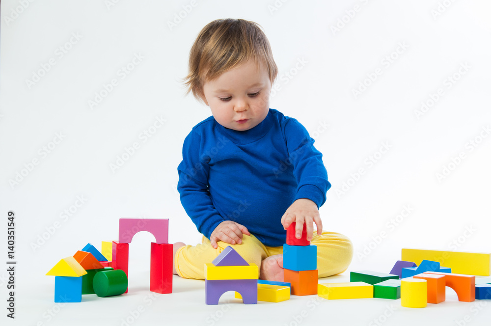 Little child playing with dices isolated on white background Little child playing with dices isolated on white background