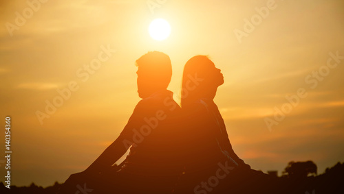 A man woman watching a sunset 