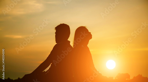 A man woman watching a sunset 