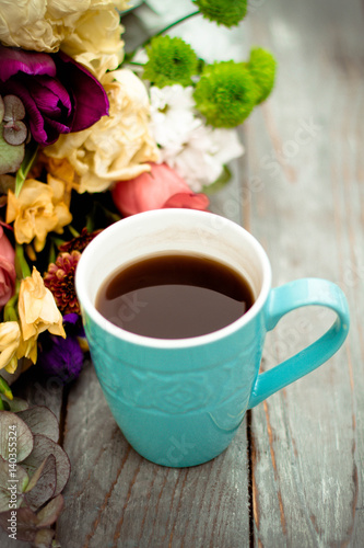 Morning Cup of coffee and a beautiful roses flowers on light background, top view. Cozy Breakfast. Flat lay style.