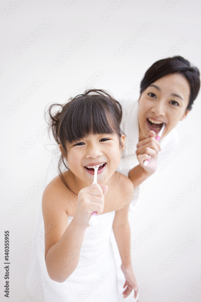 Mother and daughter brushing teeth Mother and daughter brushing teeth