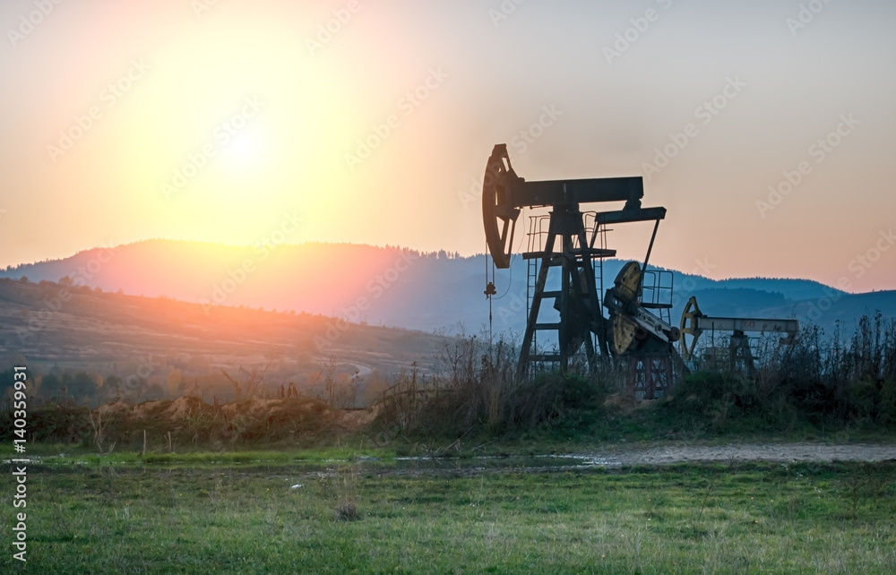 Naklejka premium oil pump on sunset