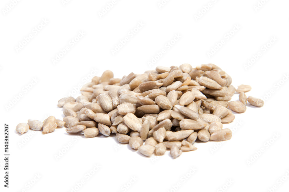 peeled sunflower seeds on white surface. isolated peeled sunflower seeds on white surface. isolated