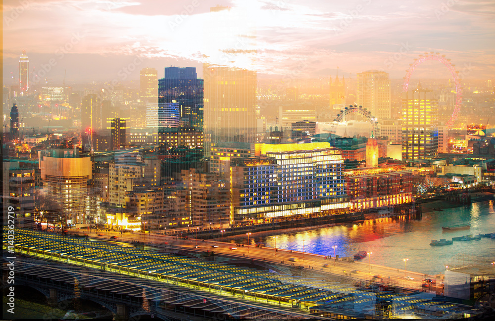 City of London at night. Multiple exposure image includes  City of London financial aria, London eye, River Thames at sunset