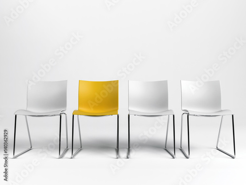Line of three white and one yellow chairs photo