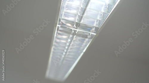 Dramatic footage of hospital ceiling light, running down corridor. 