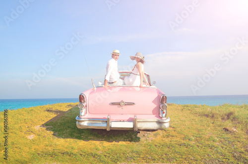man and woman in old american car