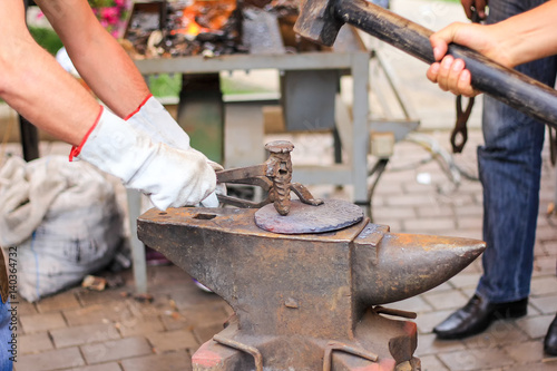 smithwith hammer and anvil © Oleksandr