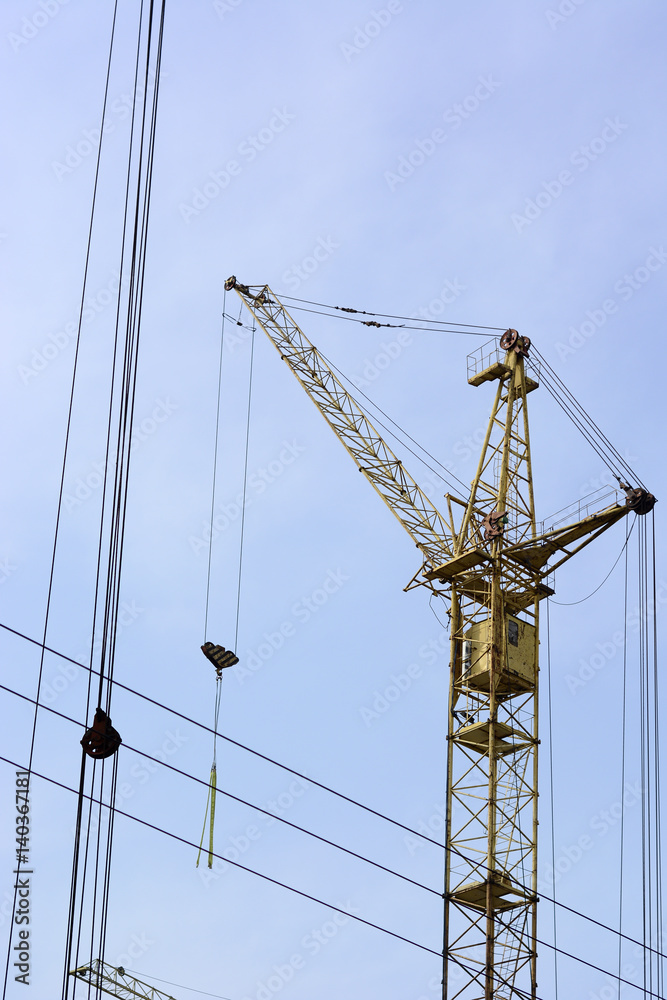 Tower cranes at construction site In the blue sky.