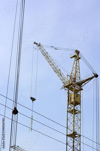Tower cranes at construction site In the blue sky.