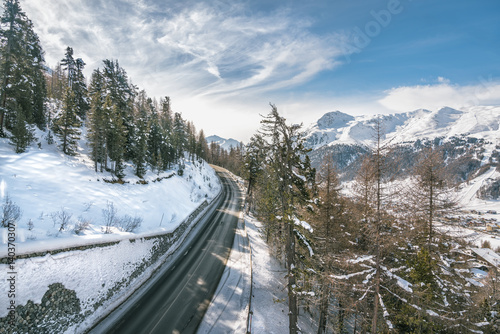 Asphalt curved road in high Alp mountains, winter season