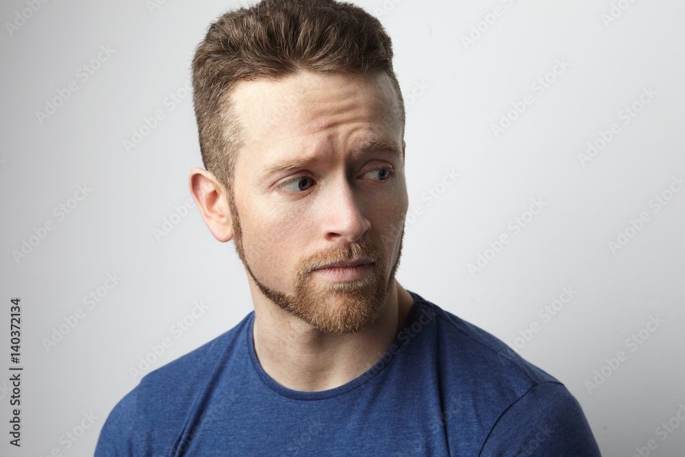 Closeup portrait of sad young man with worried stressed face expression ...