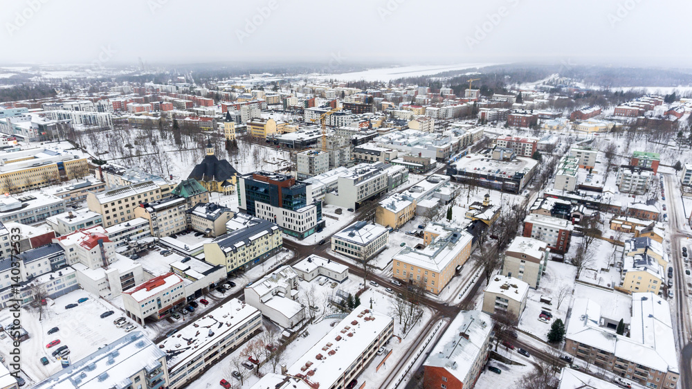 Colorful snowy roofs of houses of Lappeenranta city. Snow covered streets and roads. Finland, Europe. Aerial view