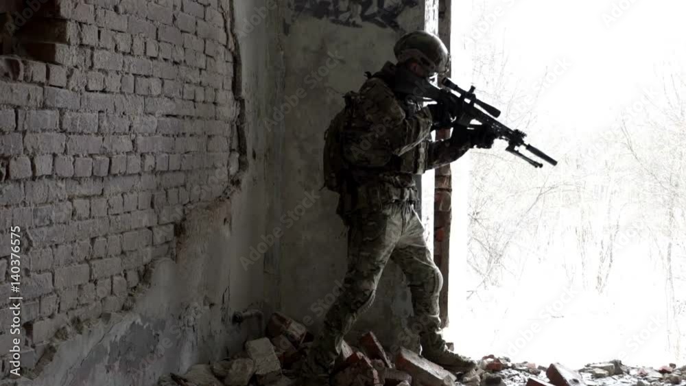 Military men with arms defending the building in winter Military men with arms defending the building in winter