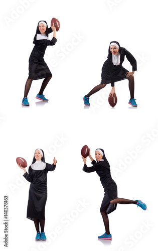 Pretty nun with rugby ball isolated on white © Elnur